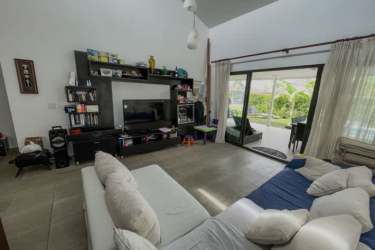Modern living area with sliding glass doors opening to patio in Coronado Panama