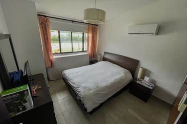 Bright guest bedroom with large window AC tile floor in Punta Paraíso Coronado
