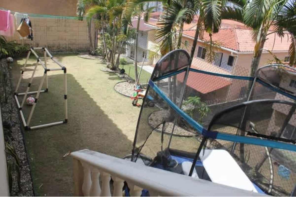 Elegant staircase with iron rail, chandelier and high ceiling in duplex home Betania Panama