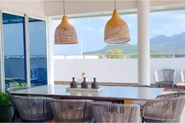 Covered patio with dining table and mountain backdrop PH Ocean Waves Panama
