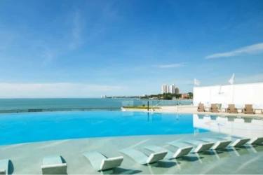 Infinity pool with submerged loungers facing ocean Ocean Waves Gorgona Panama