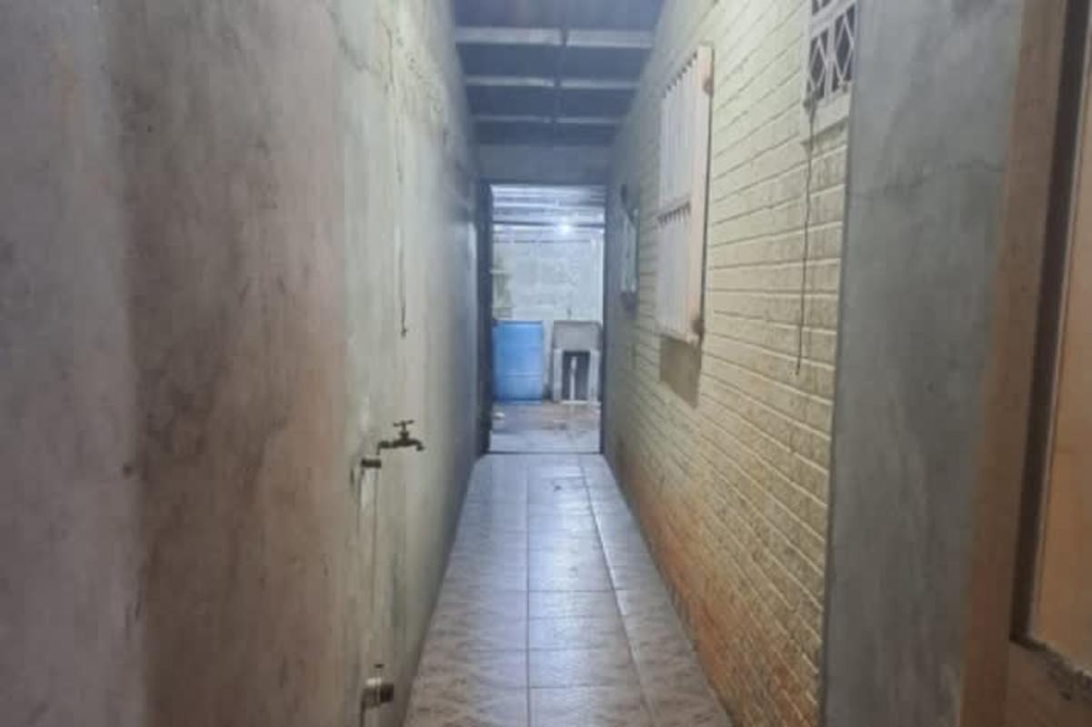 Secure entry with wooden door and window bars in affordable house Tocumen Panama