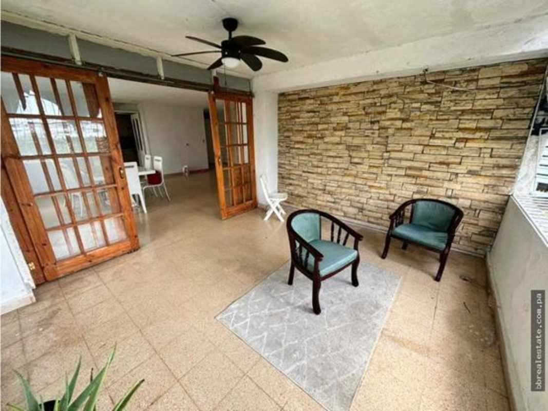 Enclosed terrace with stone accent wall, sliding glass doors, ceiling fan PH Vista del Este