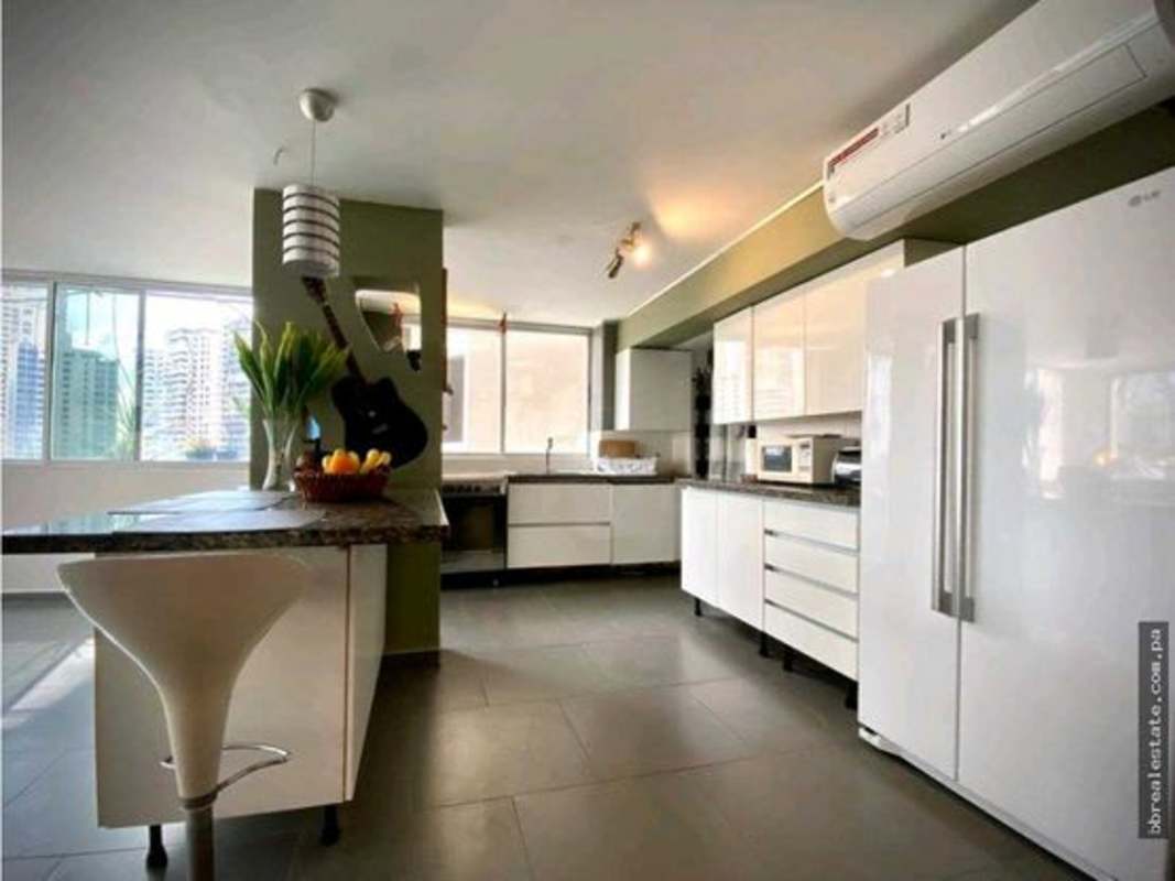 Spacious kitchen with modern cabinetry and appliances in PH La Joya apartment Punta Paitilla Panama City.