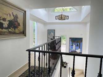 Formal dining space with large windows and natural light in luxury villa Tucan Country Club Panama