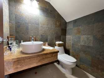 Spacious living room with large windows overlooking gardens at Tucan Country Club Cocoli Panama