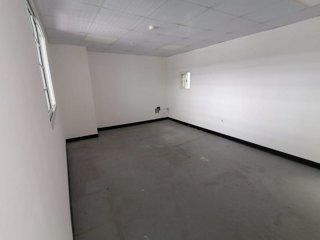 Spacious empty warehouse room with high ceiling and daylight at Costa del Este