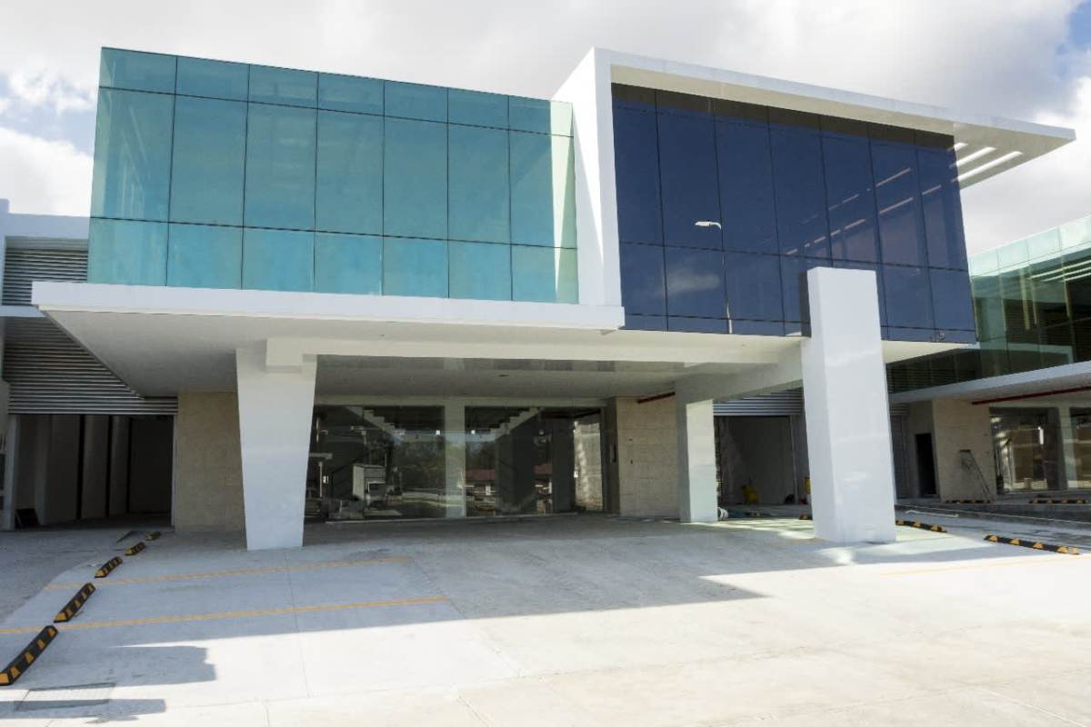 Contemporary facade of commercial warehouse in Costa del Este Business Park with glass and parking