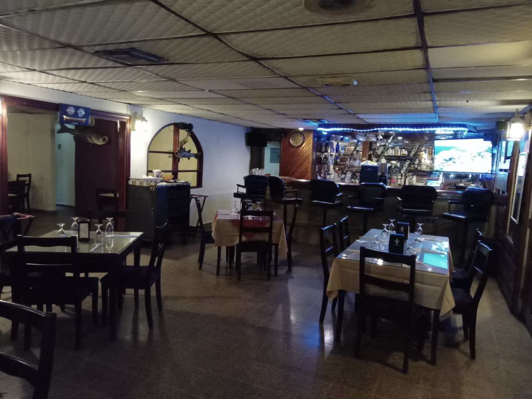 Restaurant interior with bar counter tables and ambient lighting Juan Díaz Panama