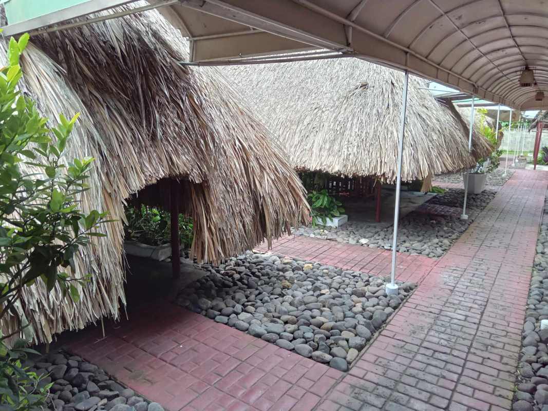 Garden seating area with traditional bohíos at commercial property Juan Díaz Panama