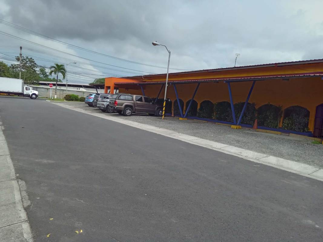 Orange and blue facade commercial building with parking Juan Díaz Panama