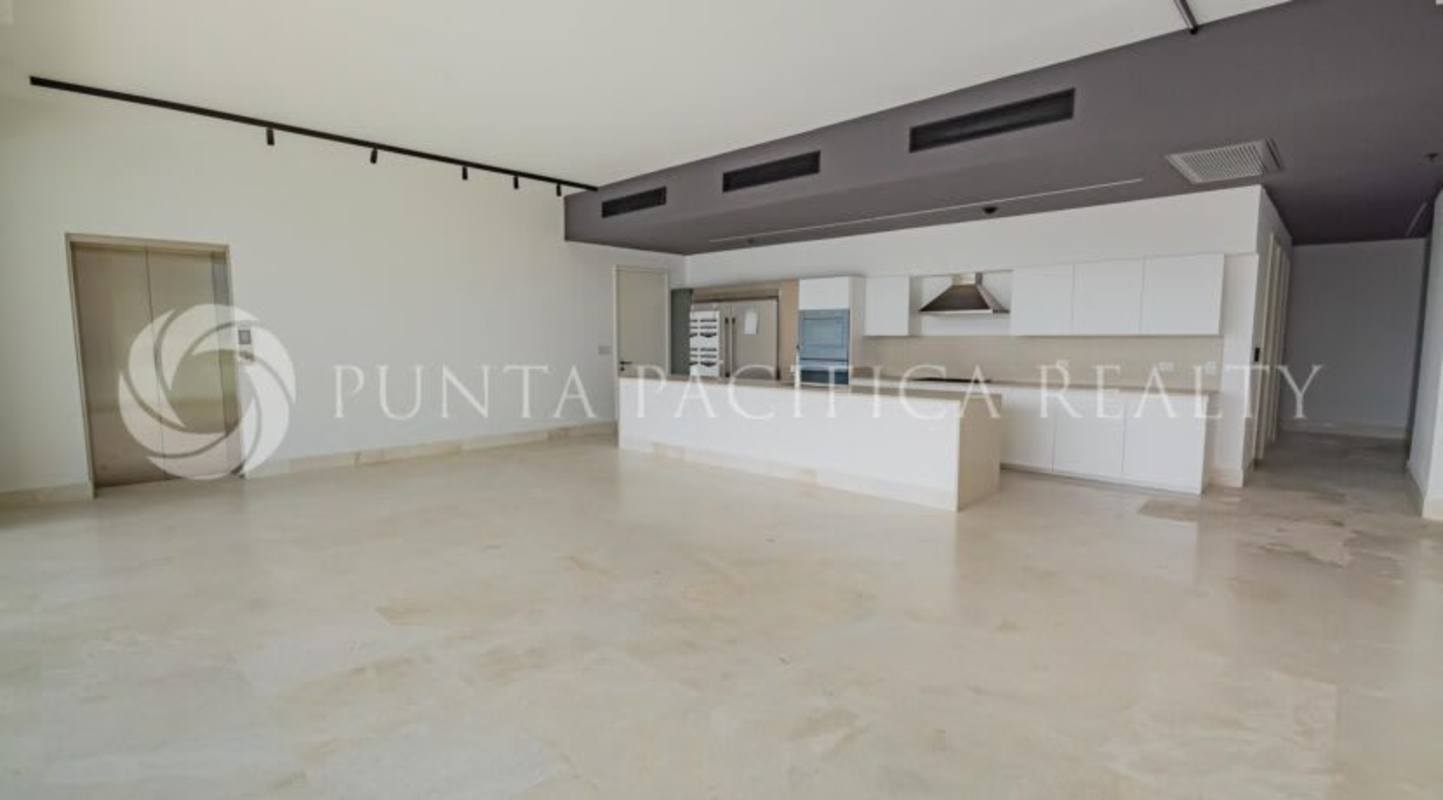 Modern minimalist kitchen with quartz countertops and large island in Beach Club Residences Ocean Reef Panama City