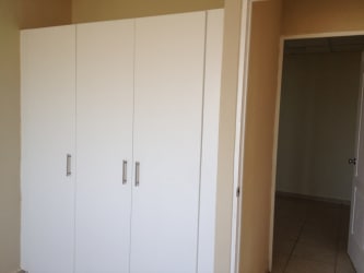 Bright bedroom space with window white walls ceiling fan house for rent Montelimar Panama