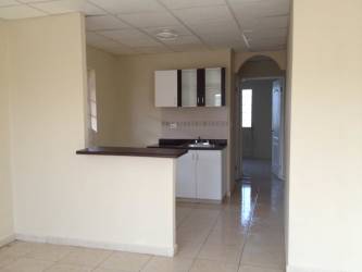 Living room with large window, security bars, ceiling fan and tiled floor in Panama house for rent