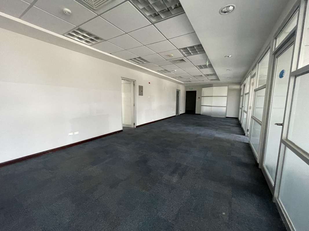Hallway in commercial office with glass partitions and suspended ceiling at Torre Canaima Panama City