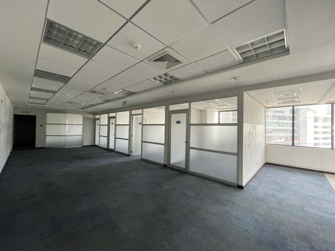 Bright open-plan office corridor with glass partitions and drop ceiling in Torre Canaima Obarrio Panama