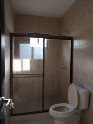 Contemporary bathroom with glass shower tiled walls in new Doral Villas house