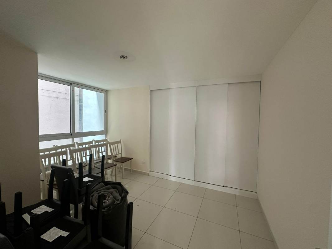 Lobby with glass doors stone walls and reception area at PH Bela Vita Panama