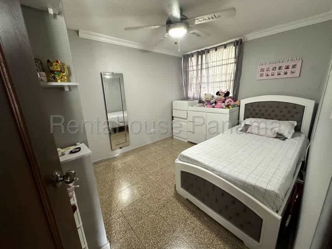 Compact kitchen with granite counter and cabinetry in affordable Carrasquilla apartment for sale Panama City