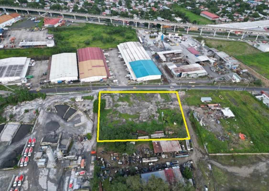 Vacant industrial-commercial lot with fencing adjacent warehouses Las Mañanitas Panama