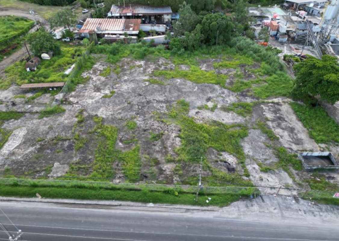 Empty fenced flat lot with road access in commercial industrial zone Las Mañanitas