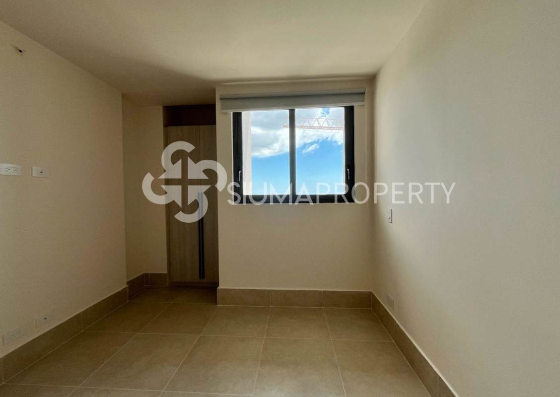 Unfurnished bedroom with large window built-in closet cityscape and golf views in Ocean House Panama