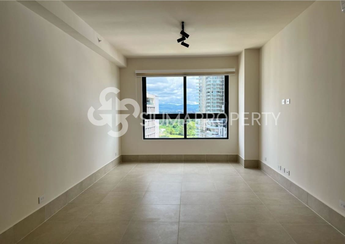 Modern living room with large windows tile floors and panoramic city views at Ocean House in Santa María Panama