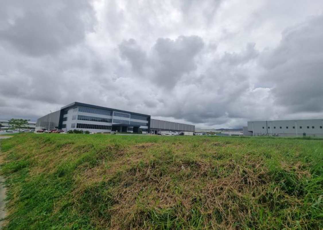 Panoramic aerial view of Tocumen Commercial Park with vacant lots, warehouses and green areas