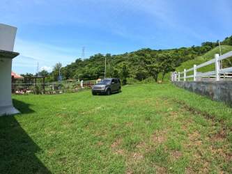 Expansive lawn area with backdrop of hills in El Espavé, Panama