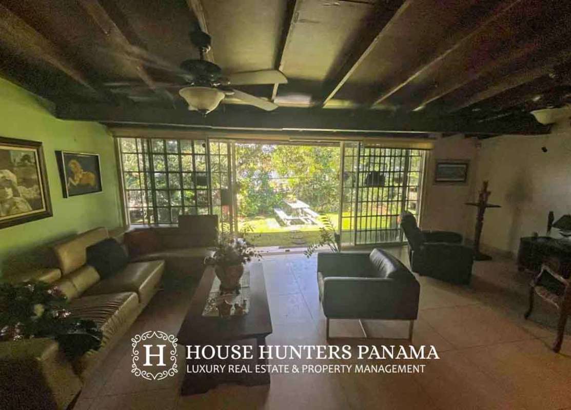 Large open kitchen with island, granite counters, rustic ceiling beams in luxury house Clayton Panama