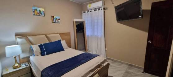 Bedroom featuring double bed, split AC, closet, mounted TV in Villa Dora 2 near Mall Terronal David Panama