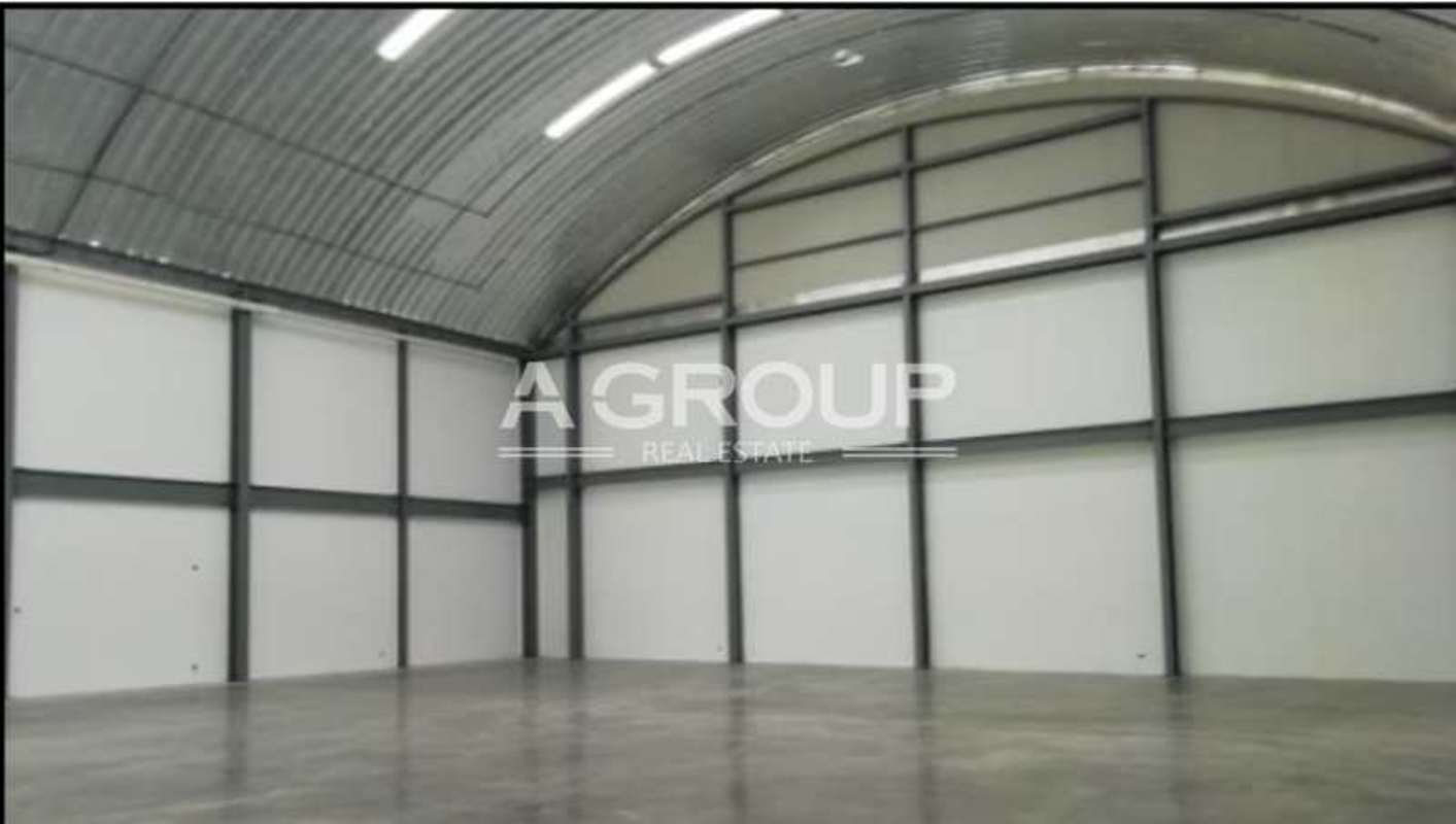Industrial warehouse interior view with steel beams polished concrete floor high ceiling at Panama Viejo Business Center