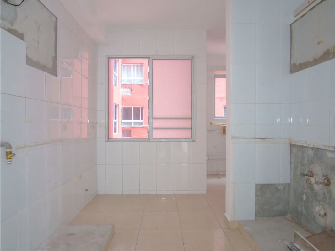 Empty kitchen space with white tile walls, beige floor tiles at PH Royal Hills Panama City