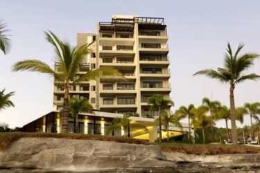Spacious open-plan living room with floor-to-ceiling windows and ocean view balcony in Punta Caelo Panama