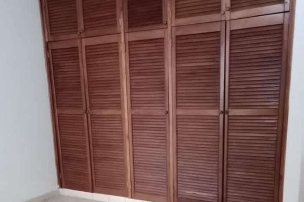 Minimalist bright living room with tiled floors and beach-themed painting at PH Bella Vista Panama City