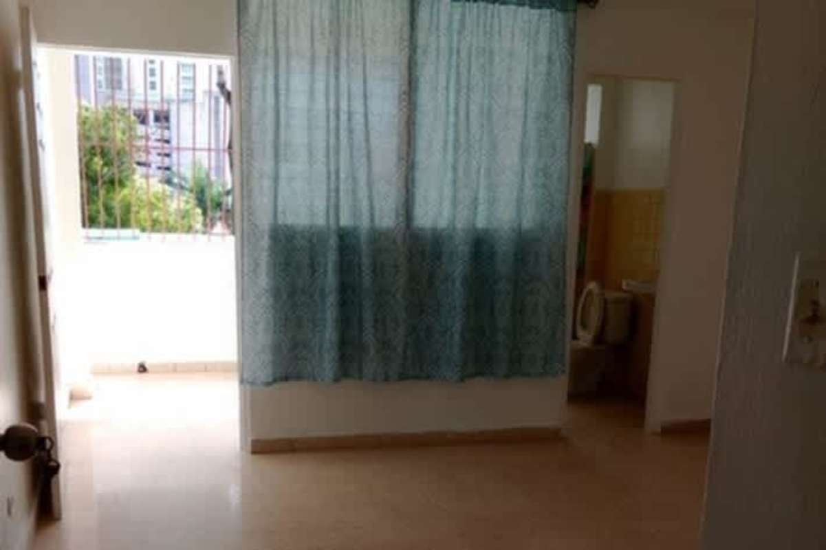 Bedroom with large built-in wooden closet, tiled floor at PH Bella Vista Residences Panama City