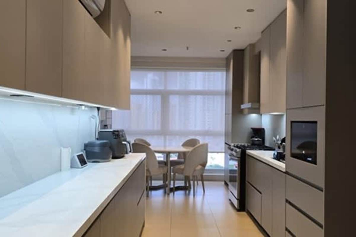Beige minimalist kitchen cabinetry integrated appliances dining nook city view PH Pacific Point Punta Pacifica