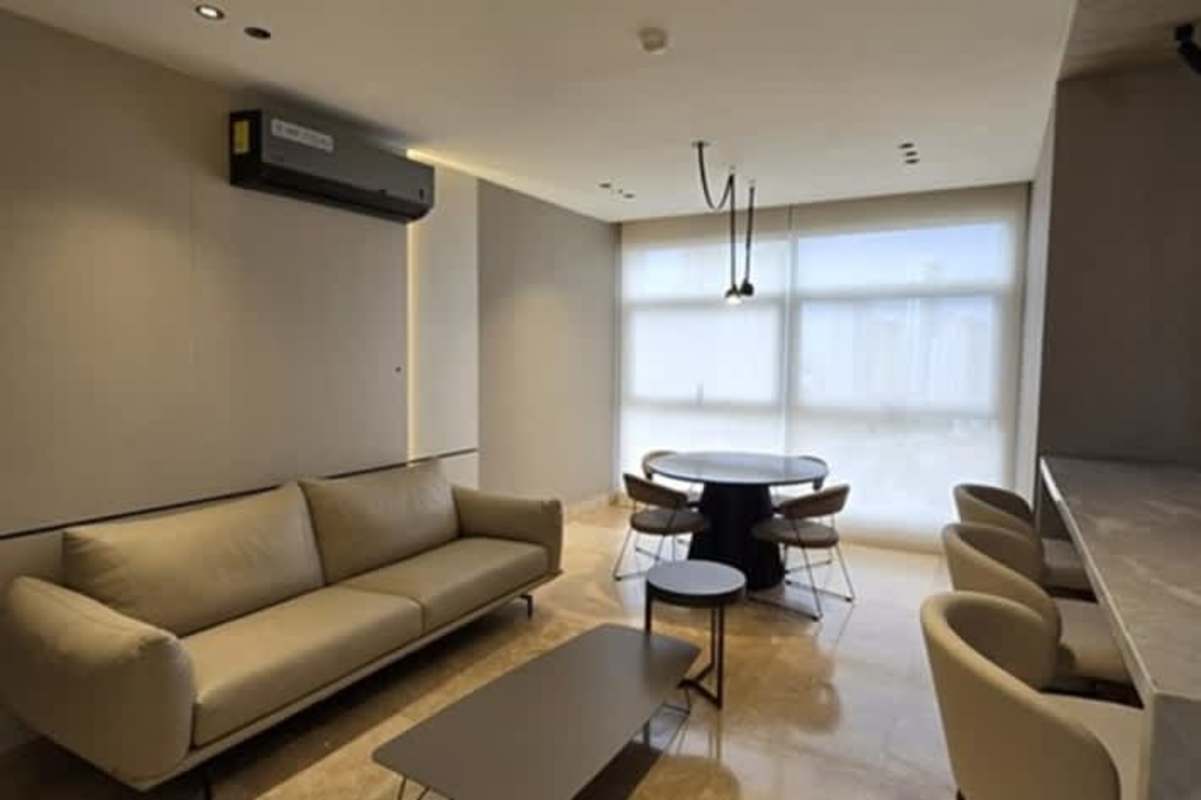 Living and dining room with floor-to-ceiling windows ocean views modern furniture PH Pacific Point