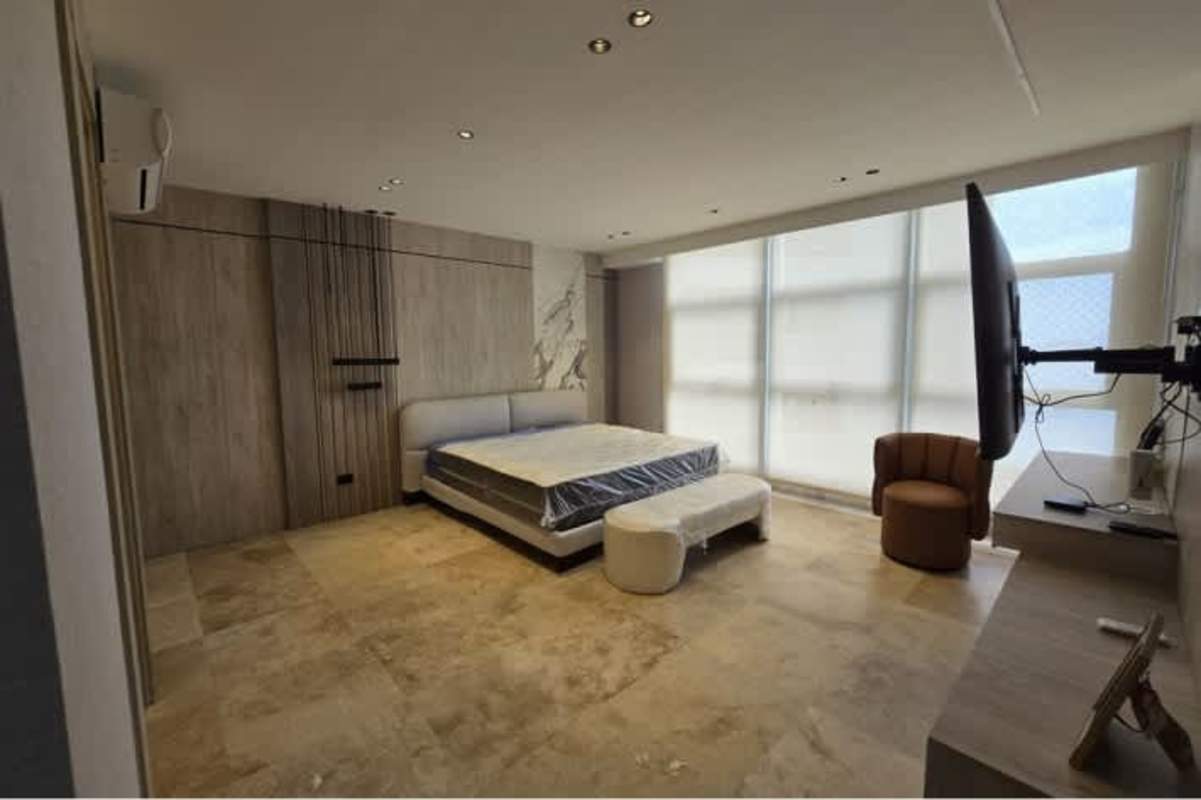 Bedroom with large windows neutral decor wall TV PH Pacific Point Panama luxury apartment
