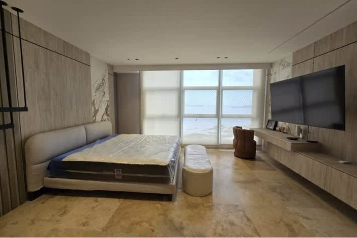 Bedroom with marble wall panels, large oceanview windows minimalist decor PH Pacific Point
