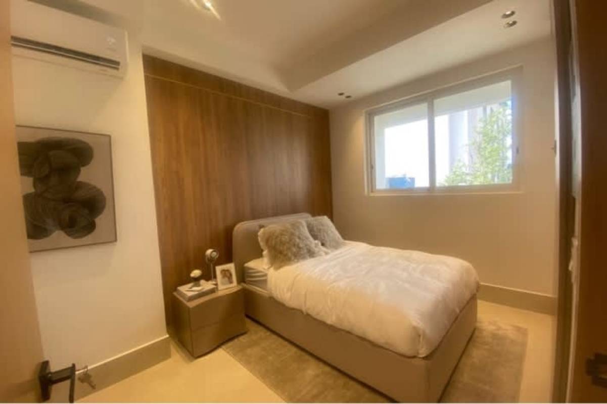 Minimalist bedroom with wood accent wall and window, luxury Santa Maria apartment