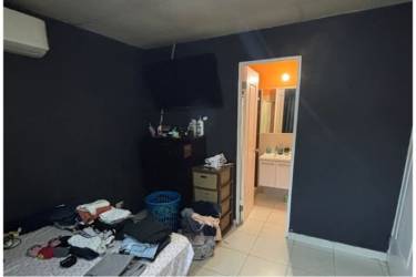 Bedroom with ensuite and mounted TV in Residencial Montelimar house Costa Verde