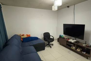 Living room with sectional sofa and tiled floors in house for sale in La Chorrera Panama