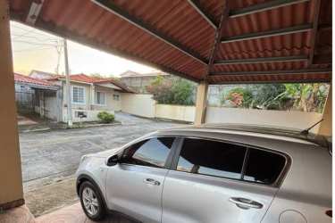 House front with covered driveway and tiled roof at Montelimar Costa Verde Panama