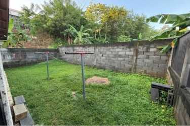 Private backyard with fence and green garden at Montelimar house Panama