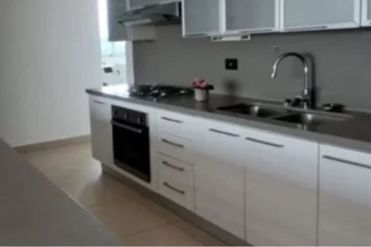 Kitchen featuring granite counters, appliances, and white cabinetry PH Clayton Park Panama