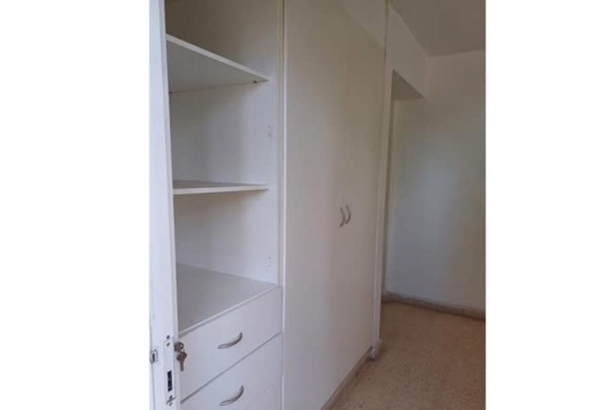 Bedroom with wooden closet bright window city view Bella Vista Panama apartment for rent