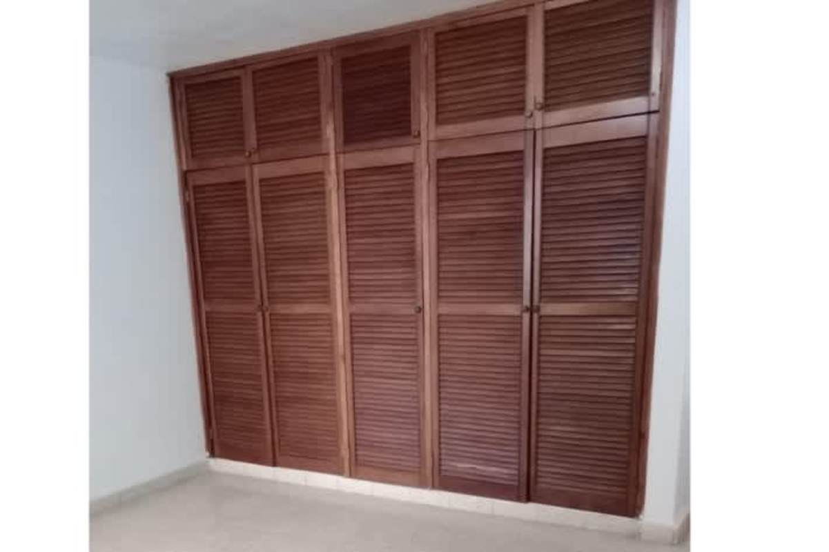 White built-in closet with drawers in Bella Vista Panama apartment bedroom for rent