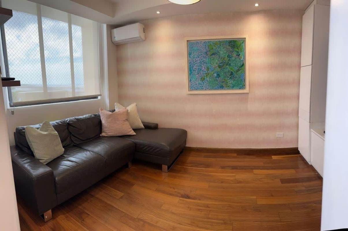 Luxury bathroom with double sink vanity, glass shower enclosure and modern tile in PH Seawaves Coco del Mar