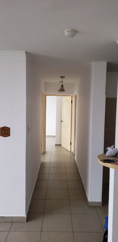 Compact kitchen with stainless sink, cabinets, tile backsplash inside PH Plaza España in Panama City
